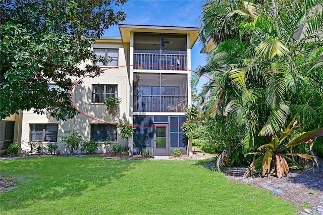 exterior space with stucco siding and a front lawn