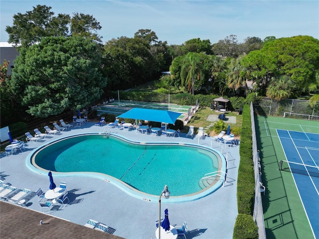 community pool featuring a patio and fence