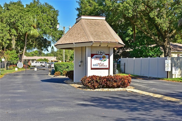 view of home's community featuring fence