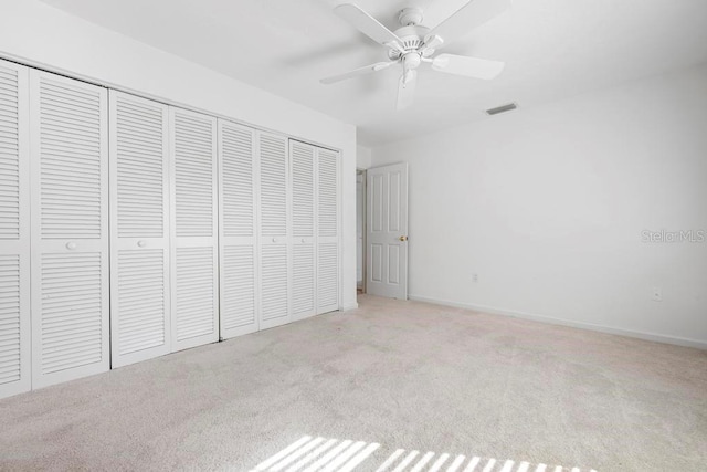 unfurnished bedroom with visible vents, baseboards, a closet, and carpet flooring