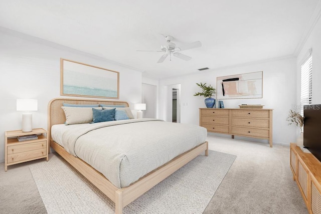 bedroom with a spacious closet, visible vents, crown molding, ceiling fan, and light colored carpet