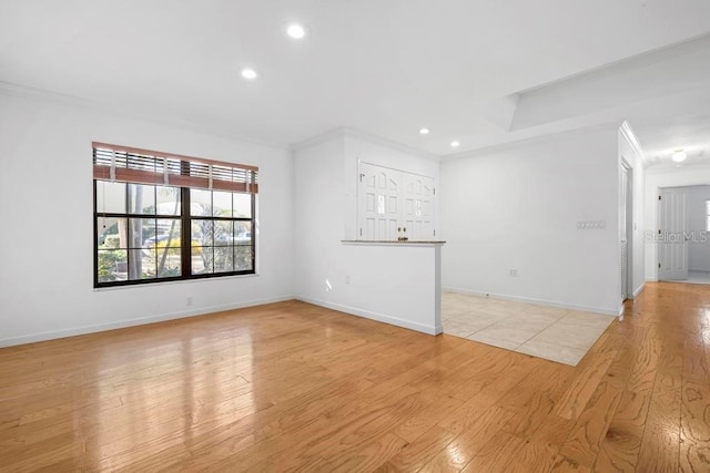 unfurnished living room with recessed lighting, crown molding, light wood-type flooring, and baseboards