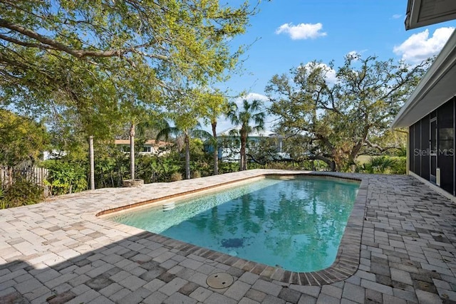 pool featuring a patio and a sunroom