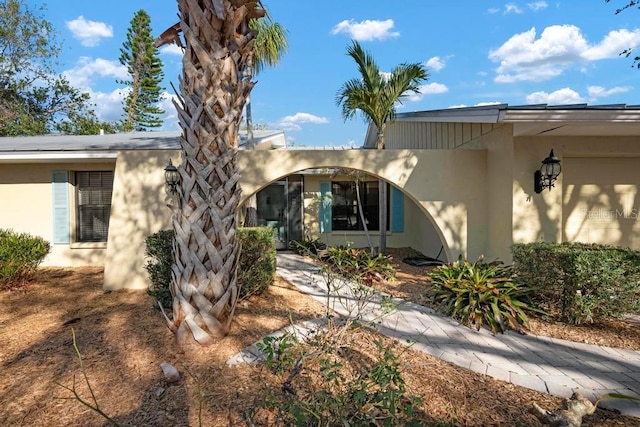 exterior space featuring a garage and stucco siding