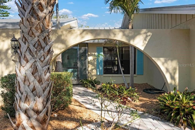 doorway to property with stucco siding