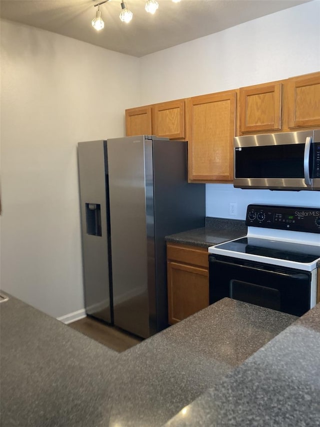 kitchen featuring brown cabinets and appliances with stainless steel finishes