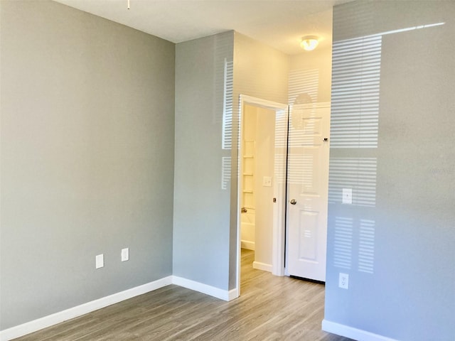 unfurnished bedroom featuring baseboards and wood finished floors