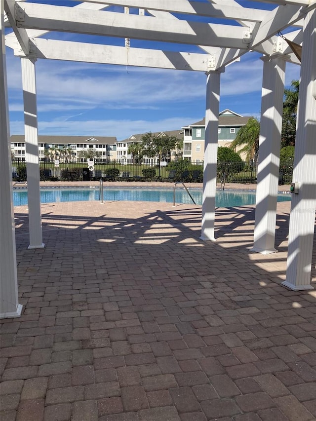 pool with fence and a pergola