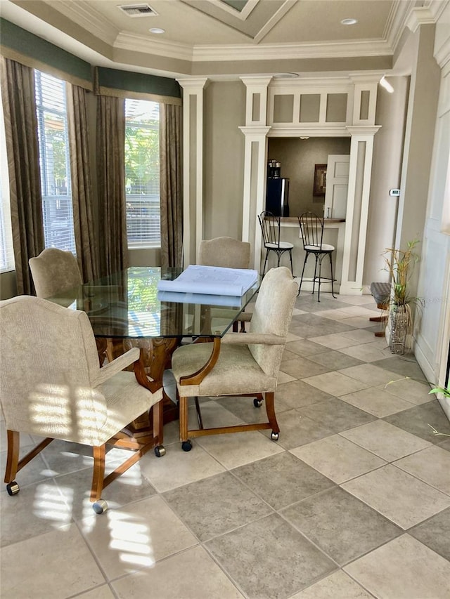 dining area with light tile patterned floors, visible vents, crown molding, and ornate columns