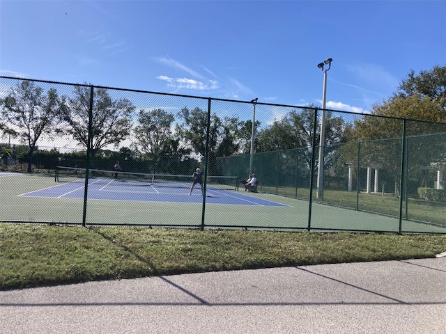 view of sport court featuring fence