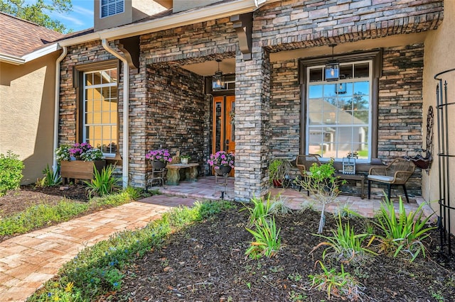 entrance to property with stucco siding and covered porch