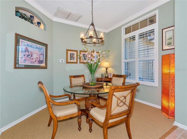 carpeted dining room with a chandelier, baseboards, visible vents, and ornamental molding