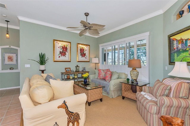 living room with a ceiling fan, baseboards, visible vents, crown molding, and tile patterned floors