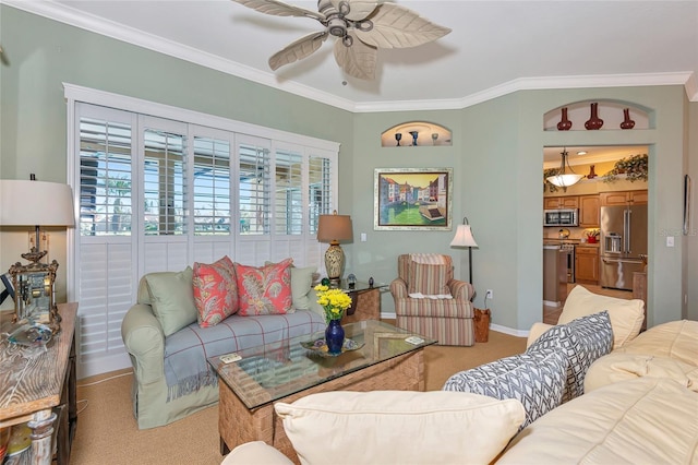 living room with light carpet, ceiling fan, baseboards, and ornamental molding