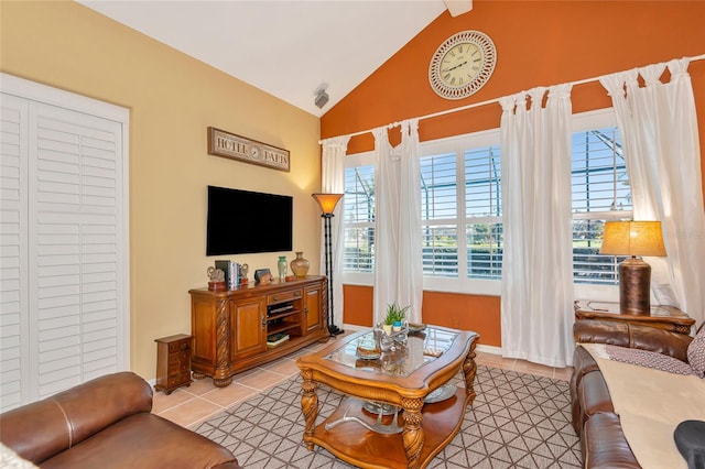 living area with light tile patterned floors, baseboards, and lofted ceiling