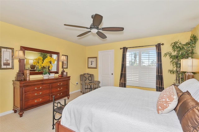 bedroom with baseboards, light colored carpet, and ceiling fan