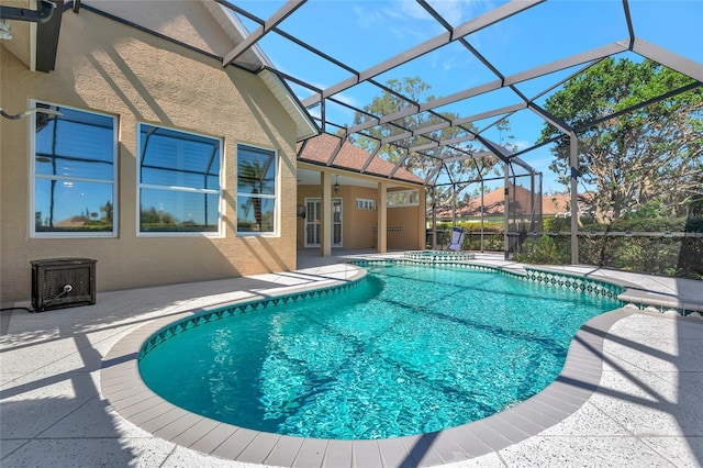 pool with a lanai and a patio area