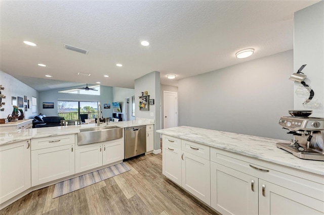 kitchen with visible vents, ceiling fan, a sink, dishwasher, and light wood-type flooring