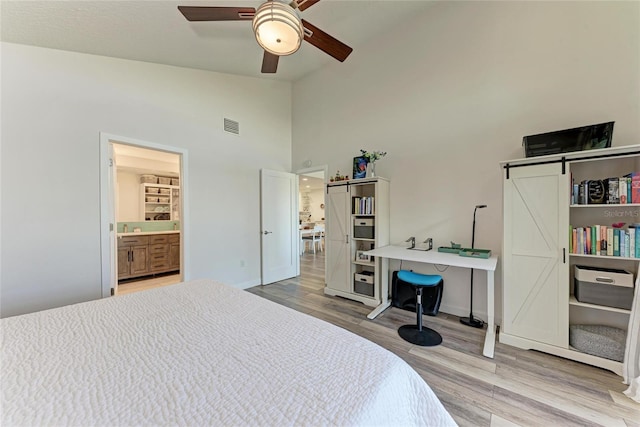 bedroom with visible vents, baseboards, wood finished floors, high vaulted ceiling, and a ceiling fan