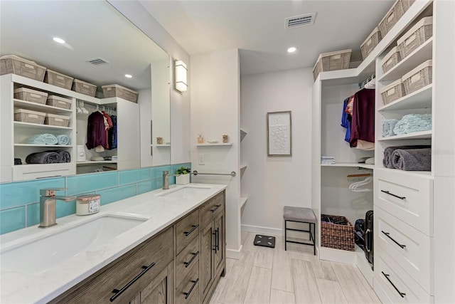 full bath featuring a sink, visible vents, and recessed lighting