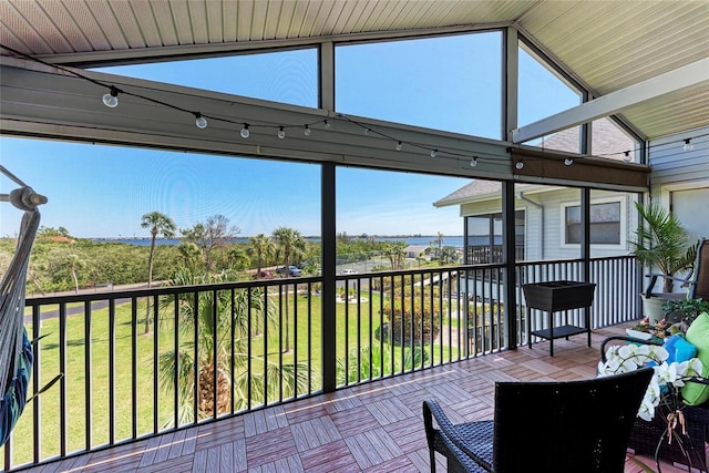 unfurnished sunroom with vaulted ceiling