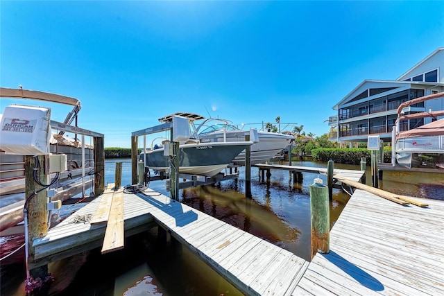 view of dock featuring a water view and boat lift