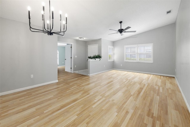 interior space with light wood-type flooring, visible vents, lofted ceiling, baseboards, and ceiling fan