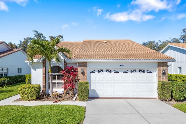 ranch-style house featuring stucco siding, driveway, a tile roof, stone siding, and an attached garage