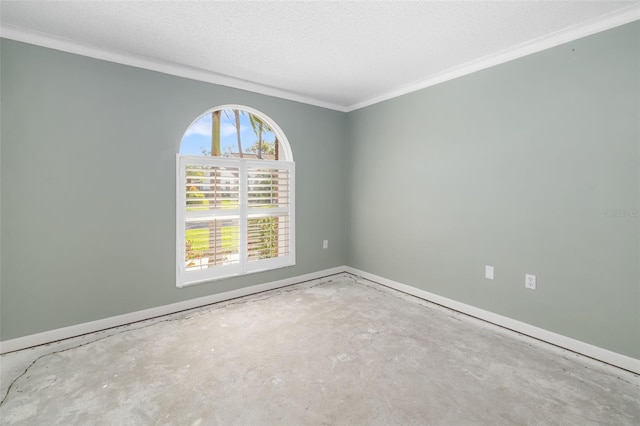 spare room featuring baseboards, unfinished concrete flooring, a textured ceiling, and ornamental molding