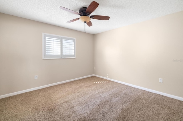 unfurnished room with baseboards, ceiling fan, a textured ceiling, and carpet