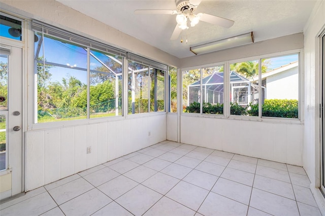 unfurnished sunroom featuring plenty of natural light and ceiling fan