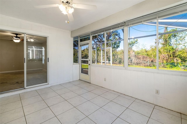 unfurnished sunroom featuring a ceiling fan