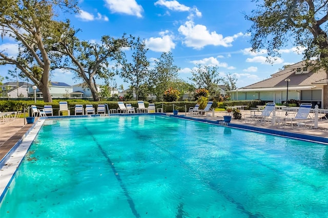 community pool featuring a patio and fence