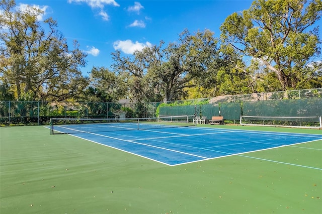 view of sport court featuring fence