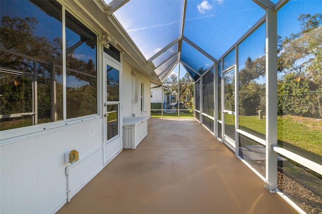 unfurnished sunroom featuring lofted ceiling