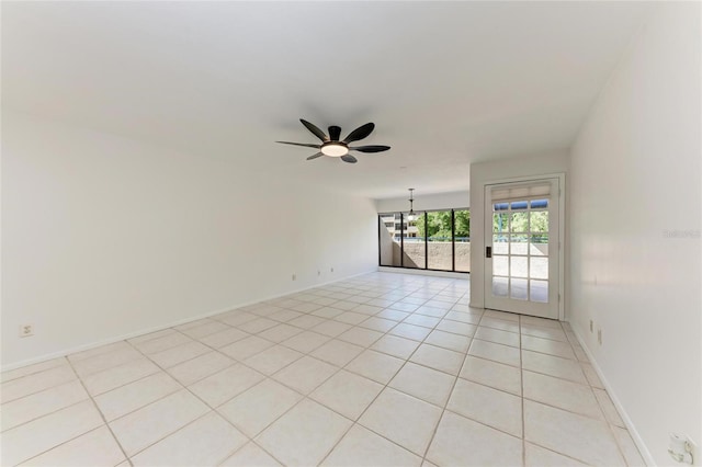 unfurnished room featuring light tile patterned floors, baseboards, and ceiling fan