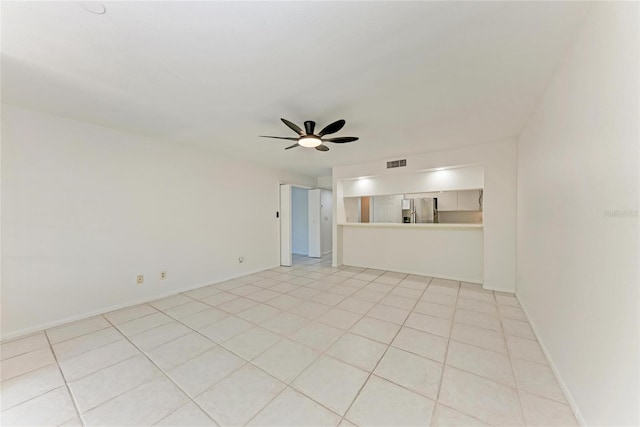 unfurnished living room with light tile patterned floors, visible vents, baseboards, and ceiling fan