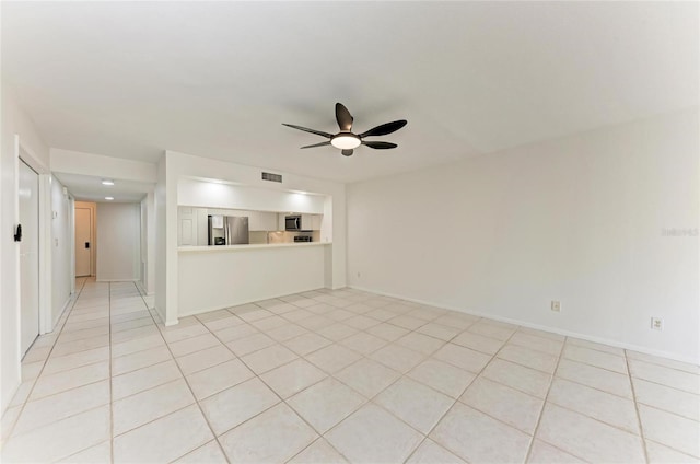 unfurnished living room featuring light tile patterned floors, a ceiling fan, visible vents, and baseboards