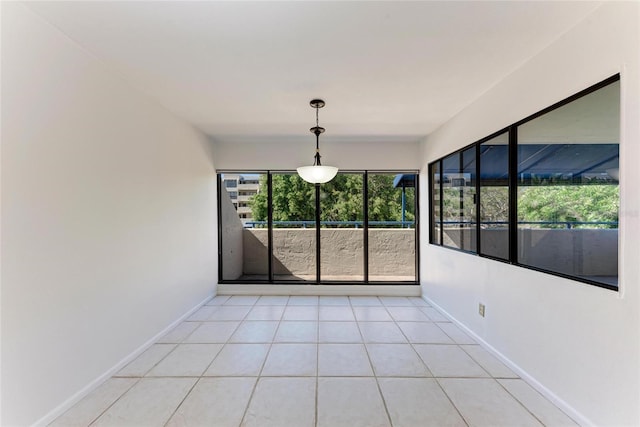 interior space featuring light tile patterned floors and baseboards