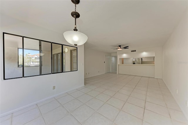 spare room with light tile patterned floors, baseboards, and ceiling fan