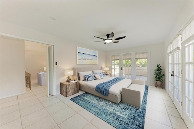 bedroom featuring a ceiling fan, access to outside, light tile patterned floors, and french doors