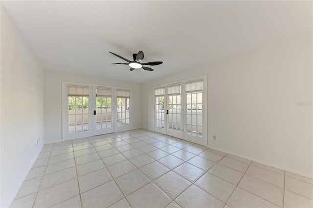 unfurnished room with light tile patterned floors, a healthy amount of sunlight, french doors, and a ceiling fan