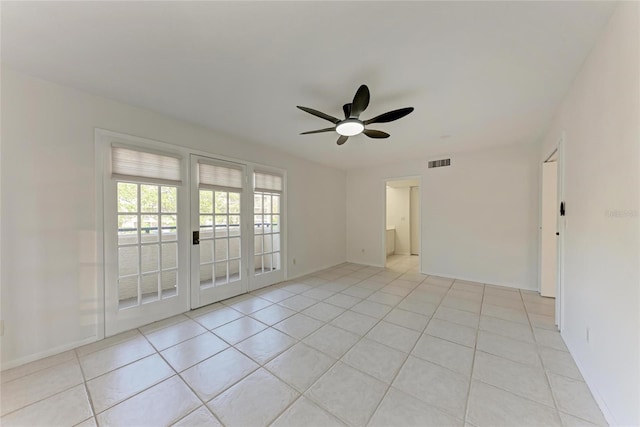 unfurnished room featuring light tile patterned flooring, visible vents, and ceiling fan