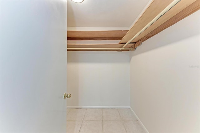 spacious closet with light tile patterned floors