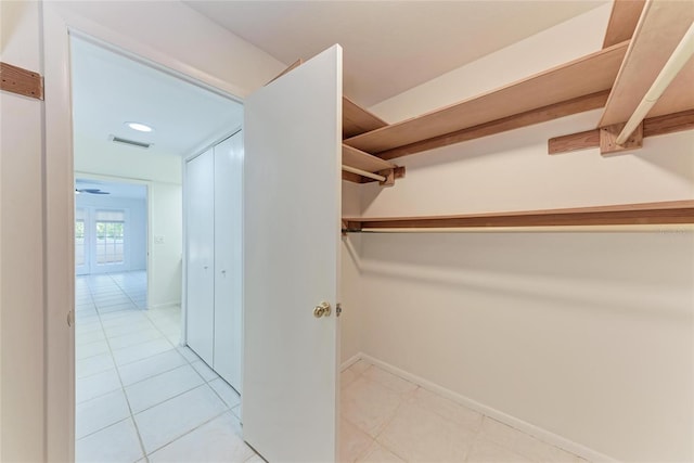 spacious closet featuring visible vents and light tile patterned flooring