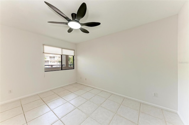 unfurnished room featuring baseboards, ceiling fan, and light tile patterned flooring