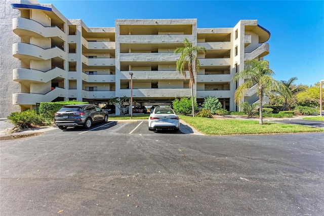 view of building exterior featuring uncovered parking