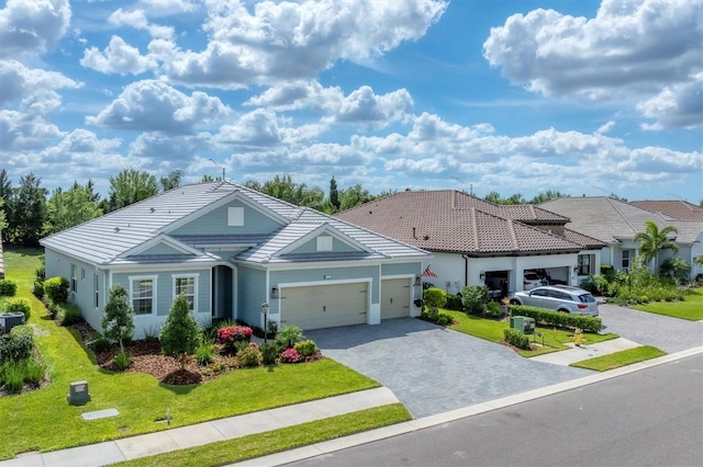 ranch-style house featuring decorative driveway, a front lawn, an attached garage, and a tile roof