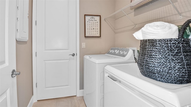 laundry room with electric panel, laundry area, light tile patterned floors, and separate washer and dryer