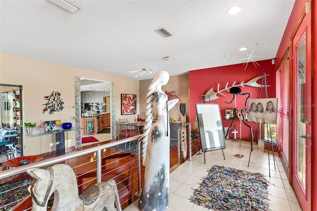 kitchen with tile patterned flooring, visible vents, and a textured ceiling